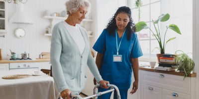 A compassionate nurse from Heal at Home Health LLC discusses chronic illness management with a patient in their home.