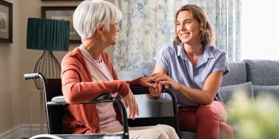 Compassionate caregiver assisting an elderly individual with meal preparation at home.