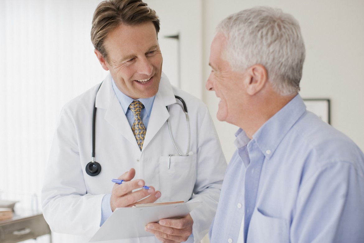 Compassionate caregiver assisting an elderly person with dementia at home in Longmeadow, MA